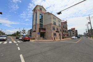an intersection with a building on a city street with cars at Boryeong Daecheon High Pension in Boryeong