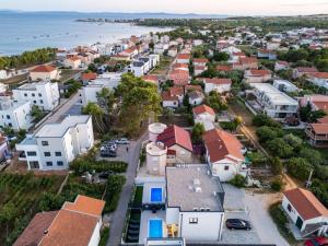 an aerial view of a town with houses and the ocean at Luxury Villa Rubi Vir - private pool in Vir
