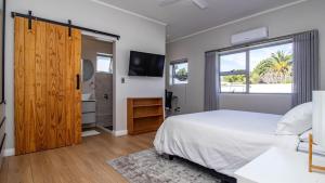 a bedroom with a white bed and a large window at Robin Retreat - Luxury 3 Bedroom Villa -Hermanus in Hermanus +36 photos