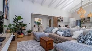 a living room with a couch and a table at Robin Retreat - Luxury 3 Bedroom Villa -Hermanus in Hermanus