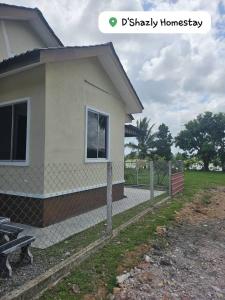 a house with a fence in front of it at D'Shazly Homestay Village in Arau