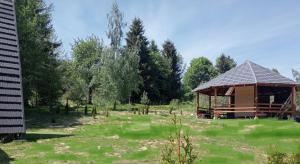 a pavilion in a field with trees in the background at Maria - Brebu Nou in Brebu Nou