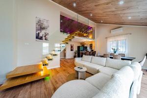 a living room with a white couch and a staircase at Villa Anita in Vela Luka