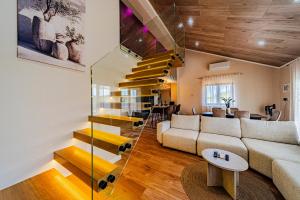 a living room with a couch and a staircase at Villa Anita in Vela Luka