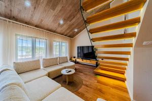a living room with a couch and a staircase at Villa Anita in Vela Luka +52 photos