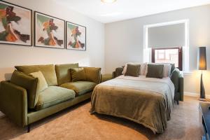 a living room with a couch and a bed at Almanythie Snug, Peterhead in Peterhead