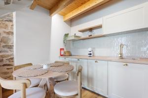 a kitchen with a table and chairs and a sink at Vila Santa Luzia 2 in Fátima +12 photos