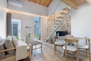 a living room with a staircase and a table and chairs at Vila Santa Luzia 2 in Fátima