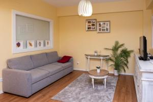 a living room with a couch and a table at RH Charming Apartment Liberdade I in Braga