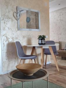 a dining room with a table and two chairs and a mirror at Apartment 11 - Free Parking in Zlatibor