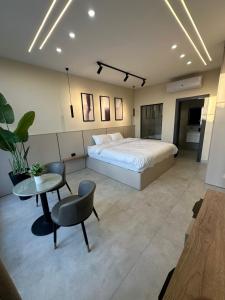 a bedroom with a bed and a table and chairs at TRIO Chalet 2 in Sowayma +29 photos