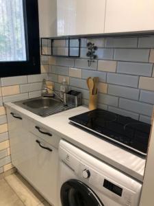 a kitchen with a sink and a stove top oven at Clos Sainte Marguerite in Lambesc