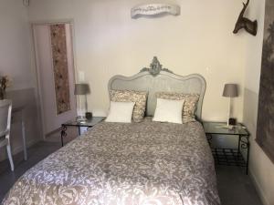 a bedroom with a large bed with two tables at Clos Sainte Marguerite in Lambesc