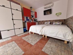 a bedroom with a large bed and red cabinets at Casita Casa la Rambla in La Romana +4 photos