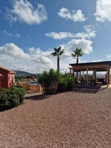 a resort with palm trees and a pavilion at Casita Casa la Rambla in La Romana