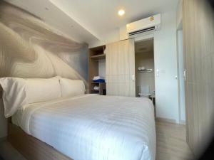 a bedroom with a large white bed in it at Sky Park Laguna Phuket in Laguna Phuket