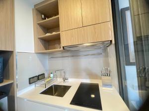 a kitchen with a sink and a refrigerator at Sky Park Laguna Phuket in Laguna Phuket +7 photos