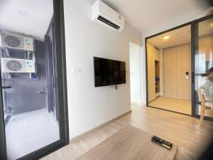 a living room with a flat screen tv on a wall at Sky Park Laguna Phuket in Laguna Phuket