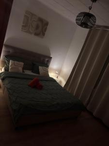 a bedroom with a bed with a red sock on it at Le Petit Refuge de Malmedy in Malmedy
