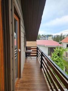 a balcony of a house with a desk on it at Guesthouse Sunshine Ureki in Ureki