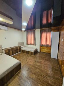 a large room with two beds and two windows at Guesthouse Sunshine Ureki in Ureki