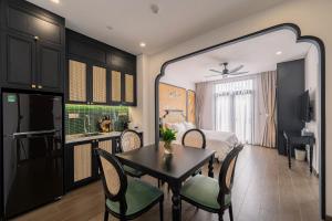 a room with a dining room table and a bedroom at AviCasa - Vinhomes Grand Park in Gò Công