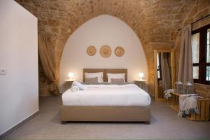 a bedroom with a large bed in a stone wall at Casa Gia By The Sea G1 & G2 in Batroûn