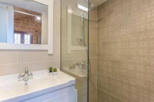 a bathroom with a sink and a glass shower at Casa Gia By The Sea G1 & G2 in Batroûn