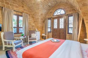 a bedroom with a large bed in a brick wall at Casa Gia By The Sea G1 & G2 in Batroûn