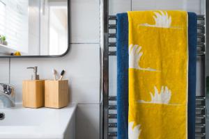 a bathroom with a yellow towel on a rack at Heath Lodge in Stockingford +34 photos