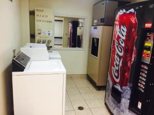 a store with a cocacola coke machine next to a store at Texas Inn and Suites Lufkin in Lufkin