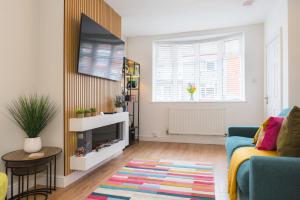 a living room with a blue couch and a mirror at Heath Lodge in Stockingford