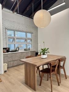 a kitchen and dining room with a wooden table and chairs at 389 Hz Homestay in Danang