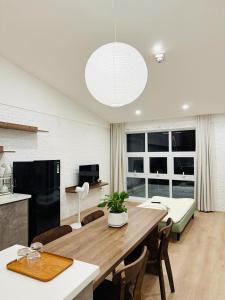 a kitchen and dining room with a large wooden table at 389 Hz Homestay in Danang