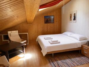 a bedroom with a bed and a table and a desk at Residenz Majesta Leukerbad in Leukerbad