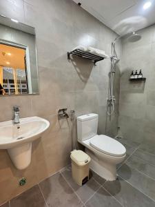 a bathroom with a toilet and a sink at 389 Hz Homestay in Danang +84 photos