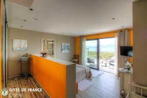 a hotel room with a bed and a balcony at La lunera in Porticcio
