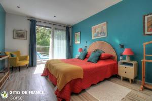 a bedroom with blue walls and a bed with a red blanket at La lunera in Porticcio +44 photos