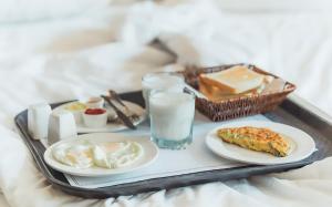 a tray with food and a glass of milk at Hillside Residence E-7 by Paramount Hospitality in Islamabad