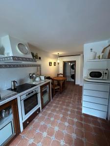 a kitchen with a stove and a counter top at La Salera - Casa Rural in Saelices de la Sal +15 photos
