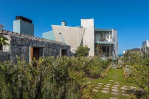 a house with a stone facade and a garden at 17 Marine - 2 Bedroom - Garden - Apt 104 in Hermanus
