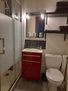 a small bathroom with a toilet and a sink at lgbt friendly in Dinan +3 photos