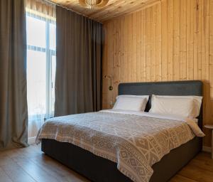 a bedroom with a large bed with a large window at Southlux in Tossor