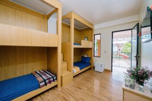 a bedroom with bunk beds and a desk at Windy Homestay in Cat Ba +33 photos