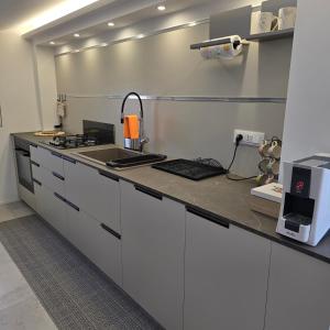 a kitchen with white cabinets and a counter top at I Secolari di Giulia in Avola