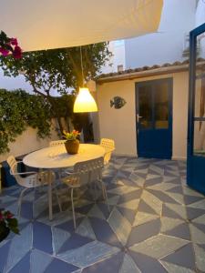 a patio with a table and chairs on a tiled floor at Casa Marietta in San Vito lo Capo