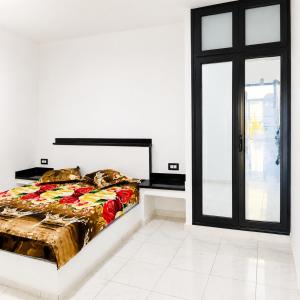a bed in a white room with a window at Casa del Mar Residences in Kelibia +26 photos