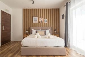 a bedroom with a large white bed with yellow stripes at Slimiza in Sliema
