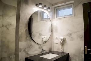 a bathroom with a sink and a mirror at Hillside Residence E-7 by Paramount Hospitality in Islamabad +16 photos