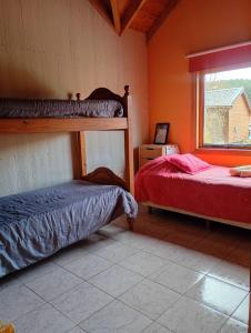 a bedroom with two bunk beds and a window at Casas Nahuilen in San Martín de los Andes
